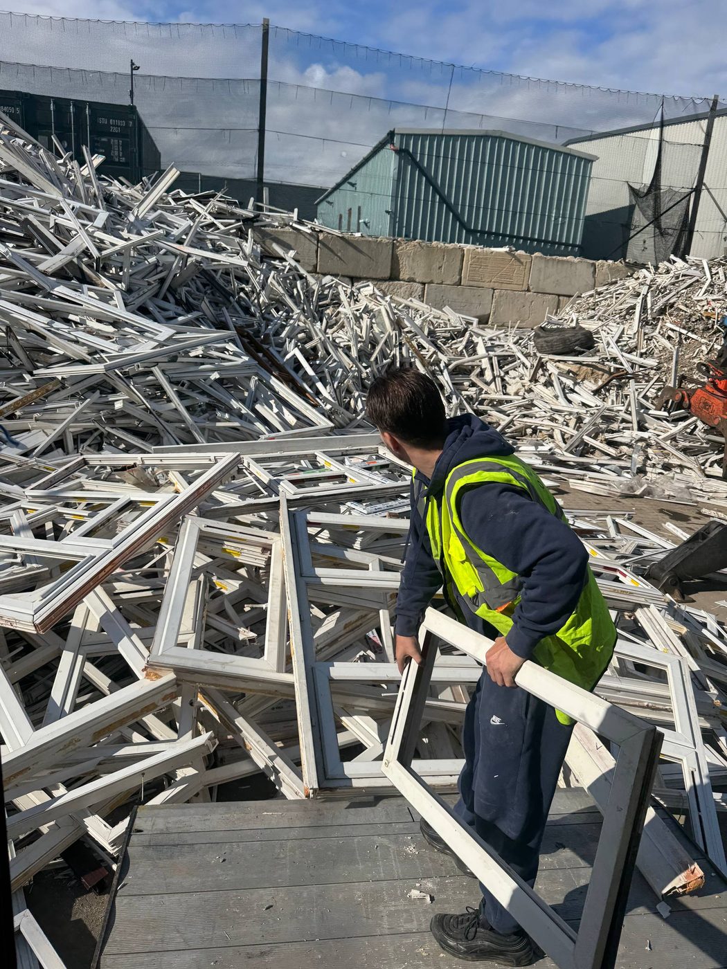 Carrying a window frame at the reprocessing yard