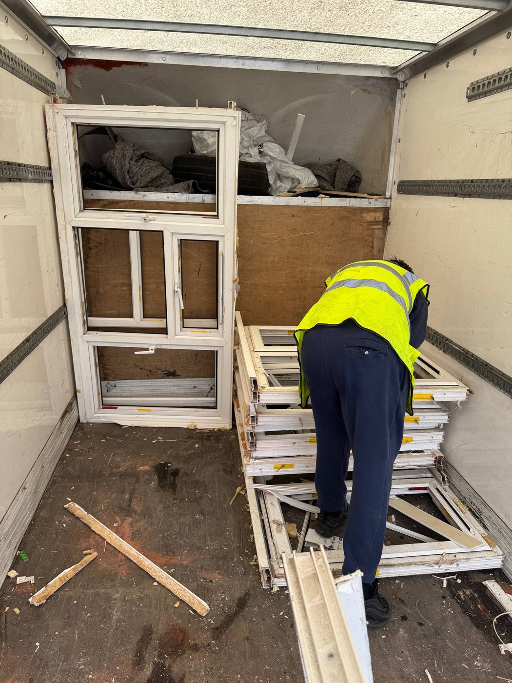 Inside the collection vehicle with window frames stacked