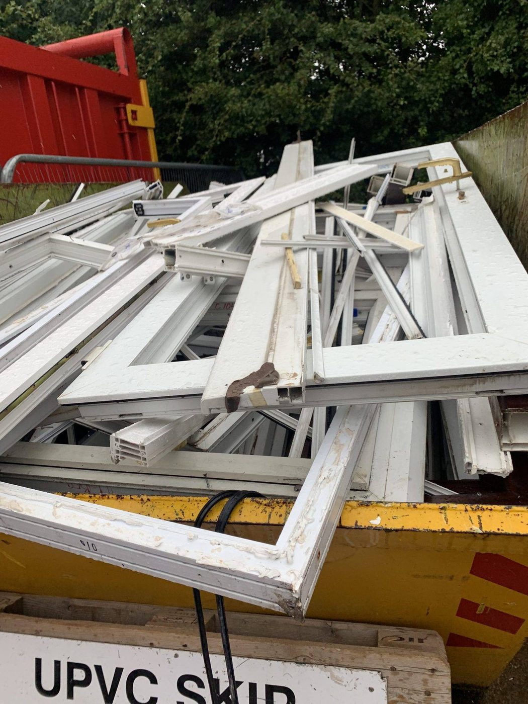 uPVC frames loaded in a skip at a London site